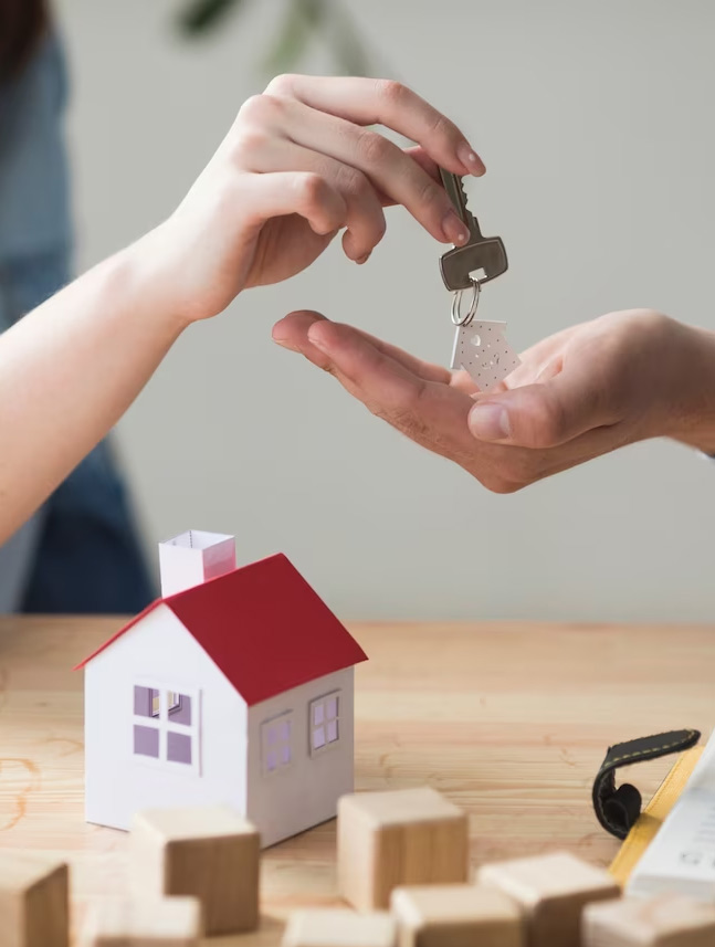 A house key is being handed over